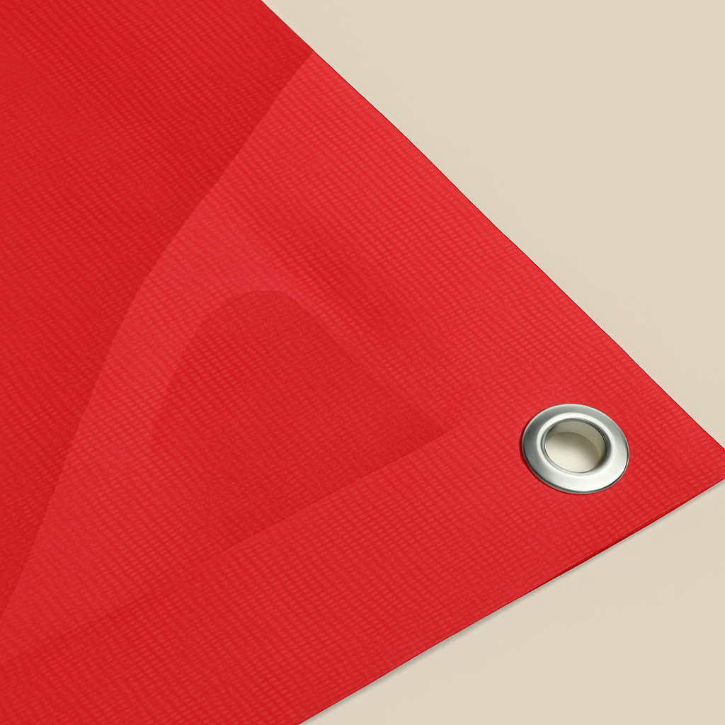 Red textured fabric with a metal grommet on a beige background