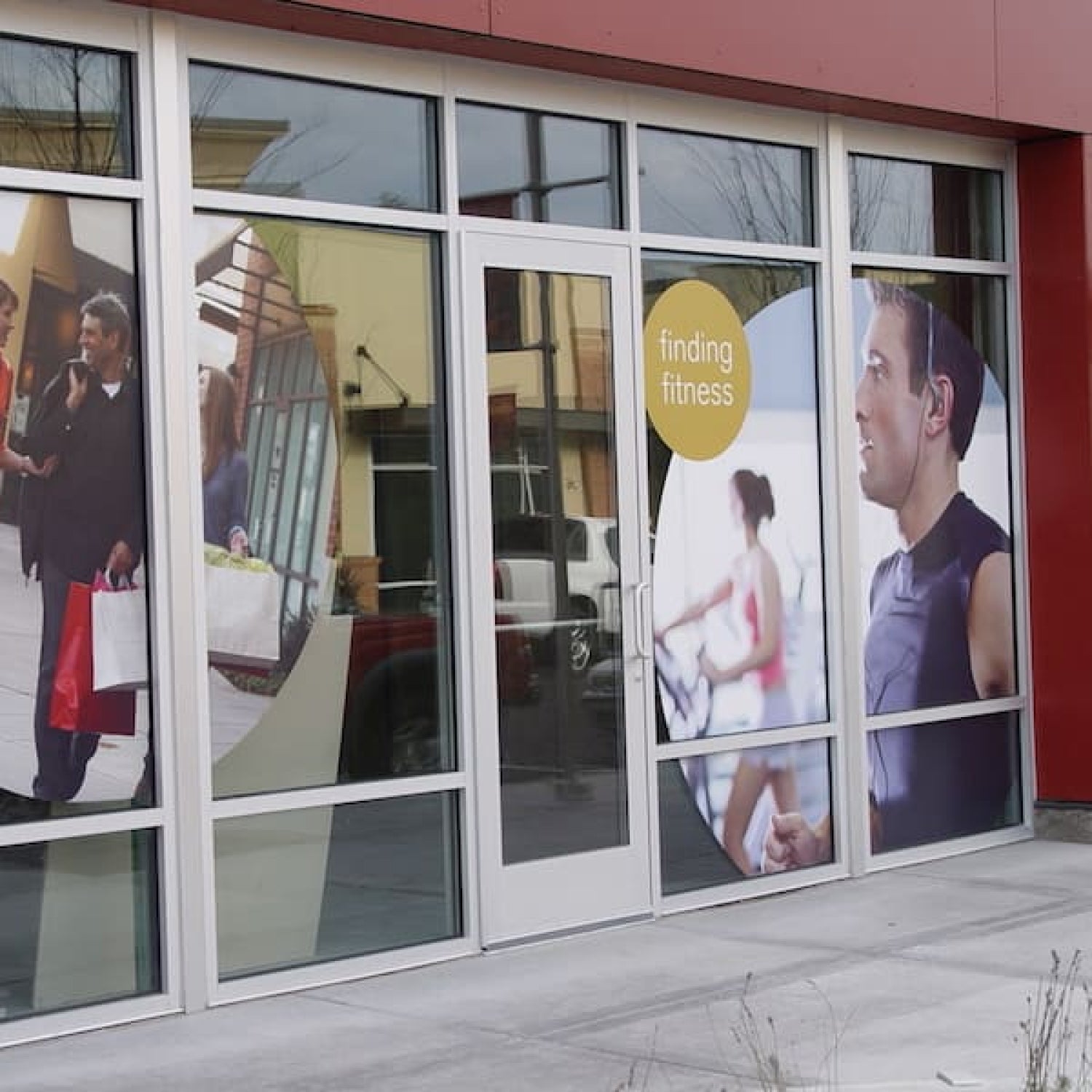 Glass door with promotional posters for a fitness center