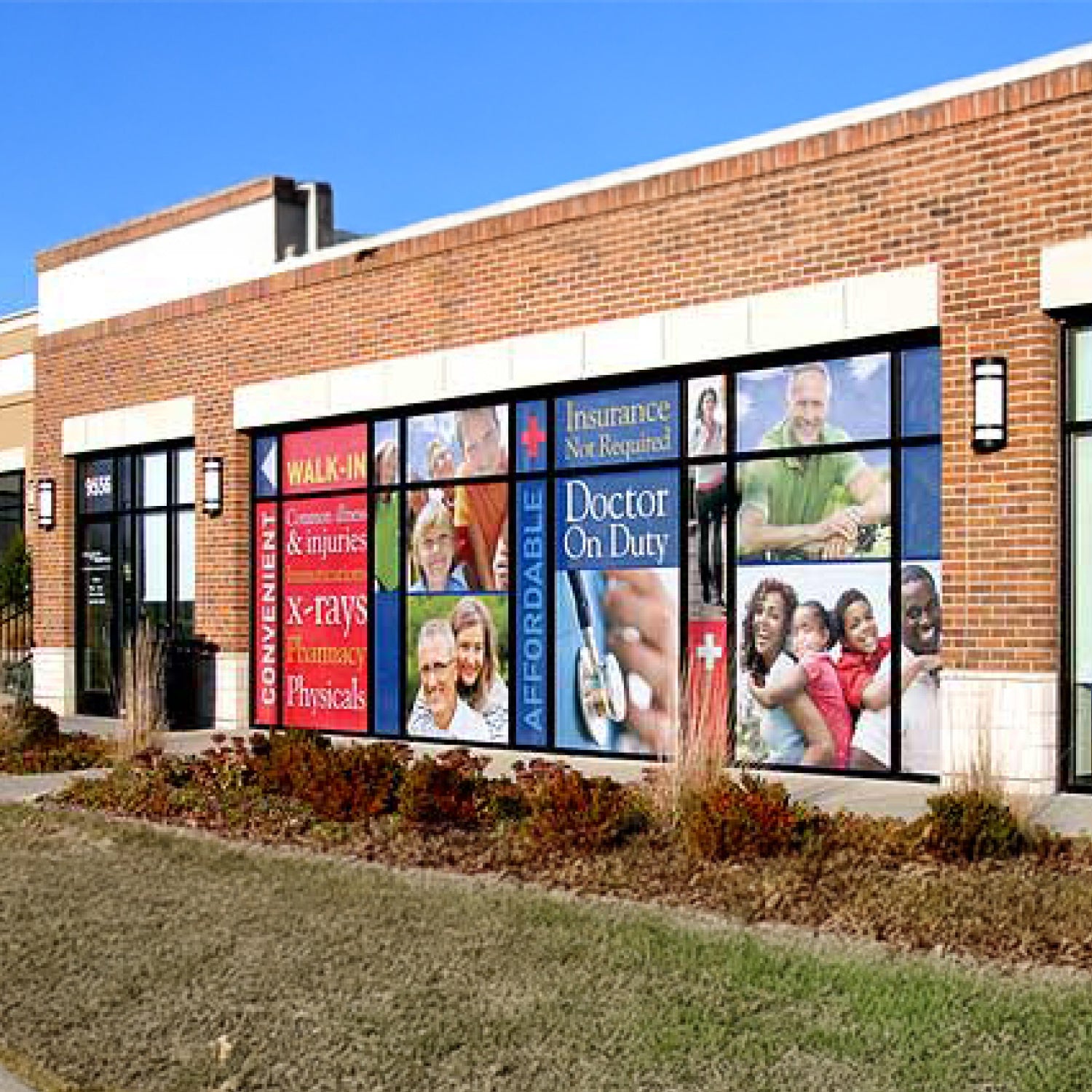 Brick building with a large window display featuring various images and text.
