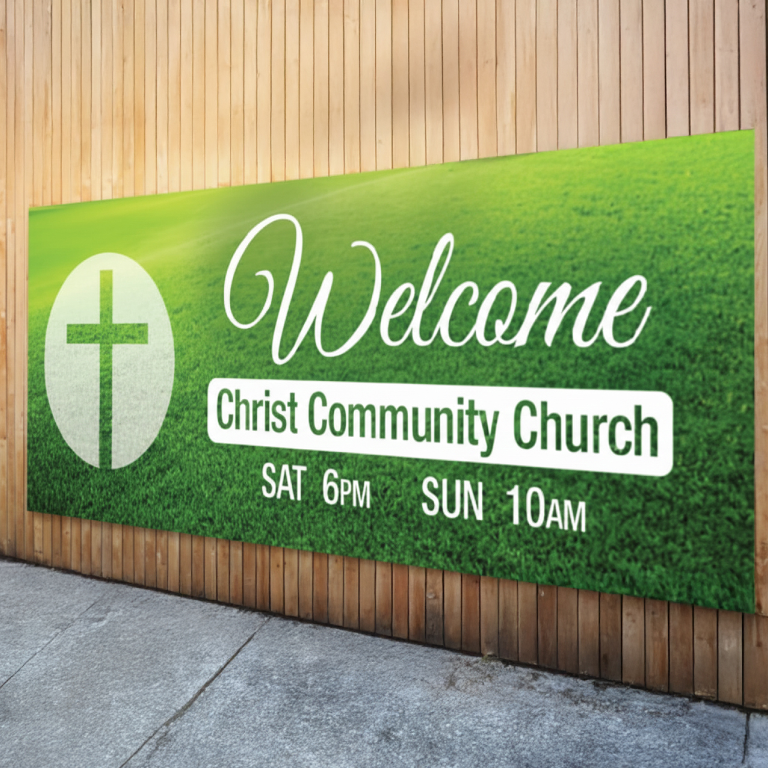 Welcome sign for Christ Community Church with a cross symbol on a grassy background.