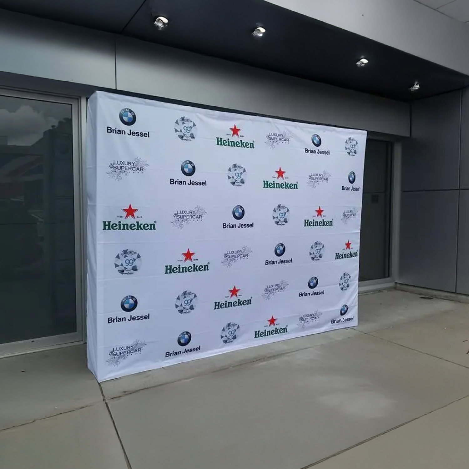 Step and repeat banner with multiple brand logos in an indoor setting
