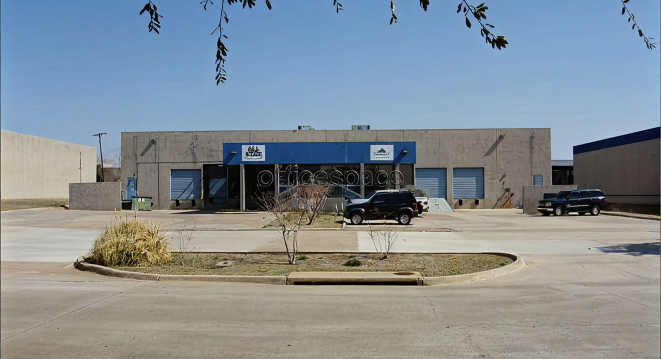 Commercial building with a blue sign on a clear day