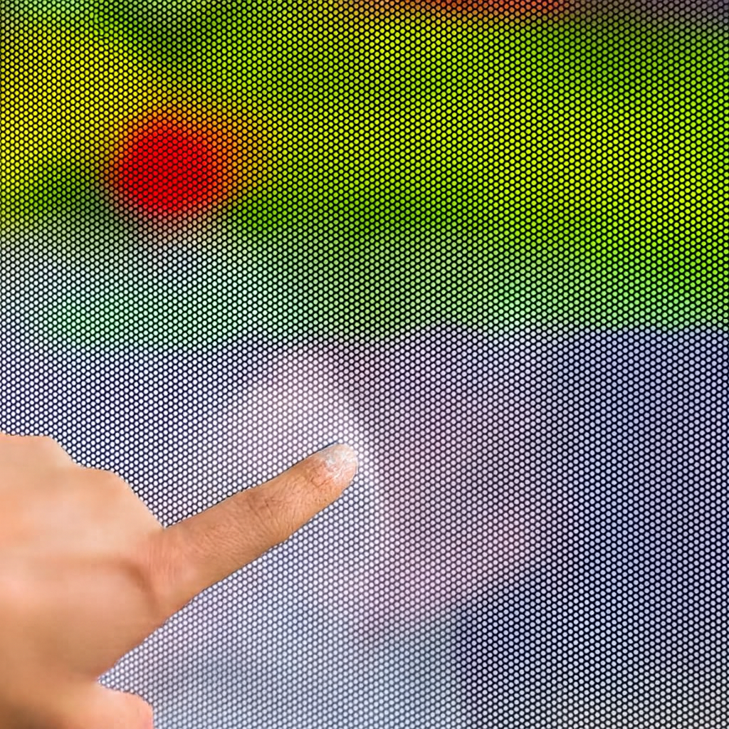 Hand pointing at a pixelated screen with colorful background
